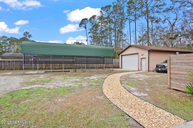 view of yard featuring an outbuilding and a detached garage