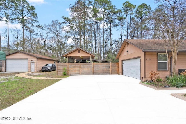 detached garage featuring fence