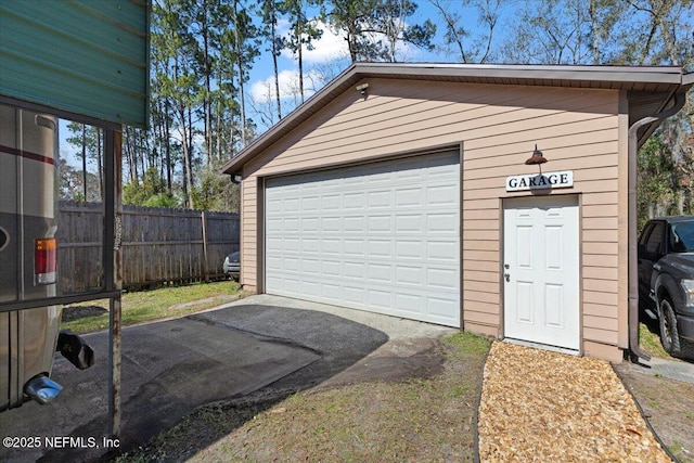 detached garage featuring fence