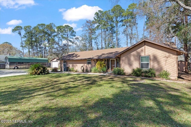 view of front of property with a detached carport and a front yard