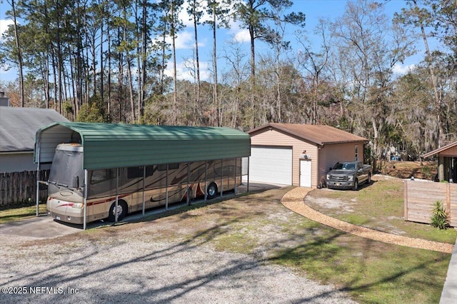 exterior space with a carport and fence