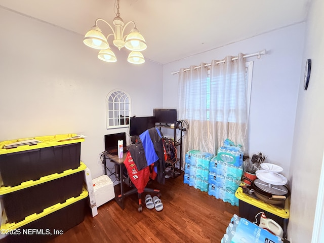 playroom with dark hardwood / wood-style flooring and an inviting chandelier