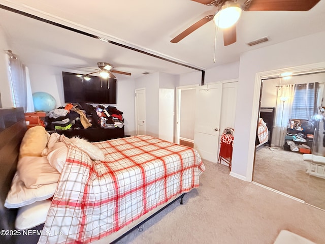 bedroom with ceiling fan and light carpet