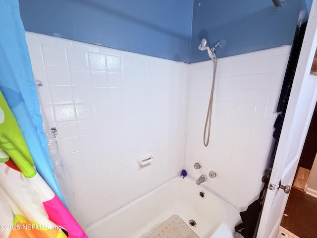 bathroom with shower / bath combo with shower curtain