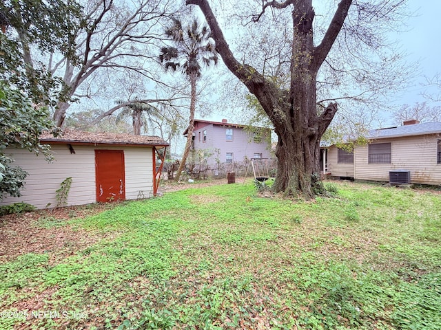 view of yard featuring cooling unit and an outdoor structure