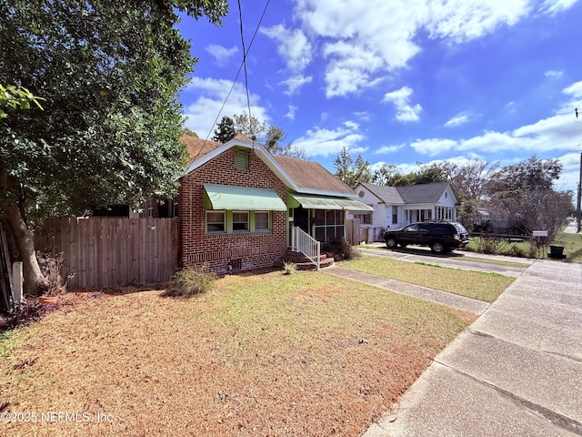 bungalow-style house with a front yard