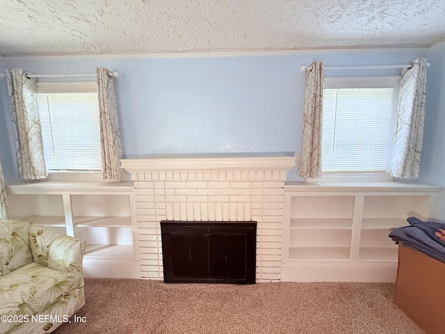 unfurnished living room featuring a brick fireplace, carpet, and a textured ceiling