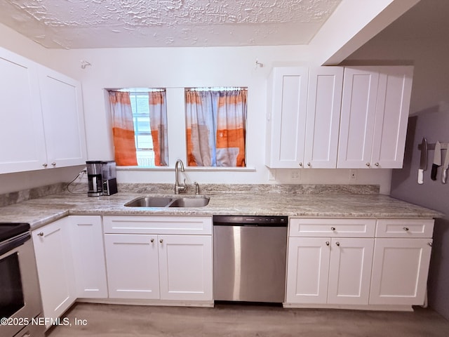 kitchen with white cabinetry, dishwasher, and sink