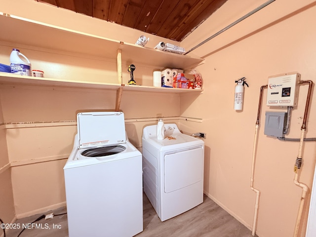 washroom with wood ceiling, independent washer and dryer, and light hardwood / wood-style floors