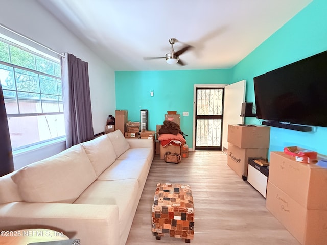 living room featuring light hardwood / wood-style flooring and ceiling fan