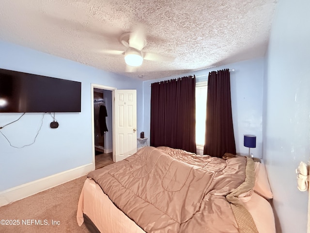 bedroom featuring ceiling fan, light carpet, and a textured ceiling