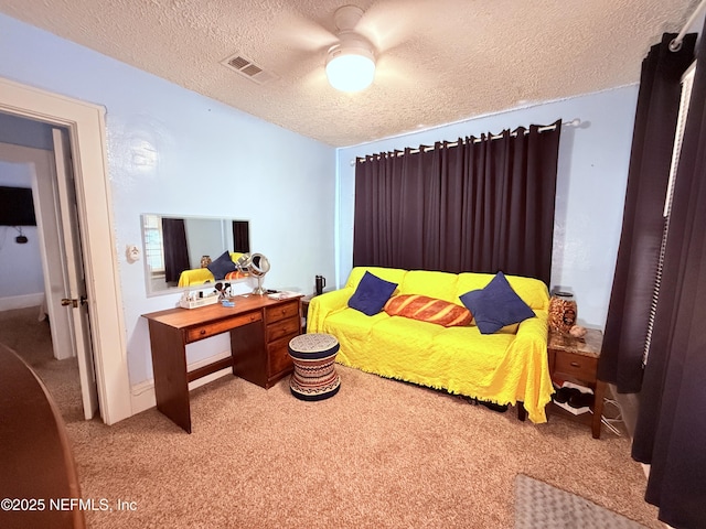 carpeted bedroom with ceiling fan and a textured ceiling