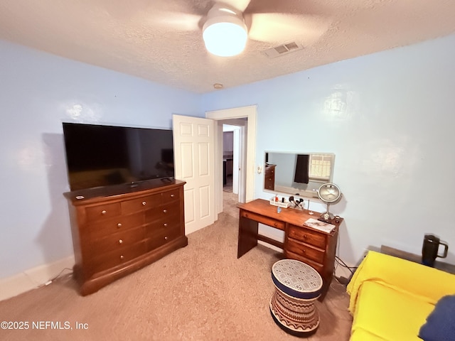 carpeted office with a textured ceiling