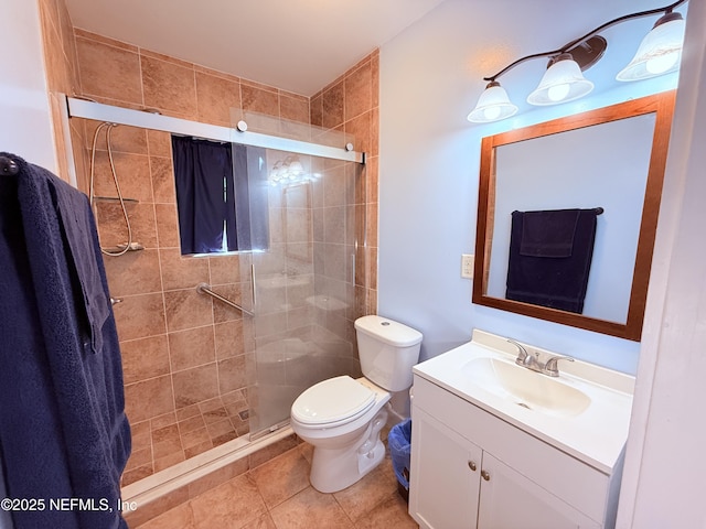 bathroom with vanity, tile patterned flooring, toilet, and walk in shower