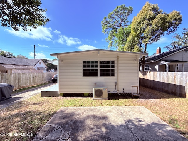 rear view of property with a patio and ac unit