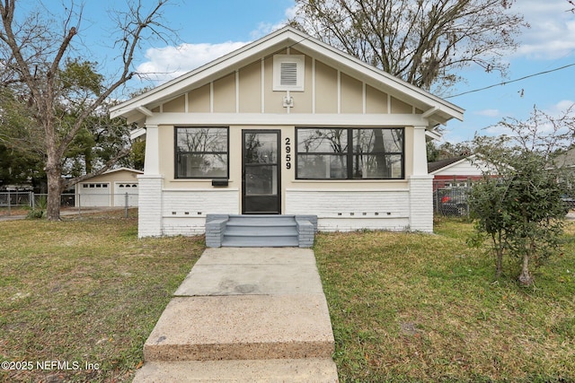 bungalow-style house featuring a front yard