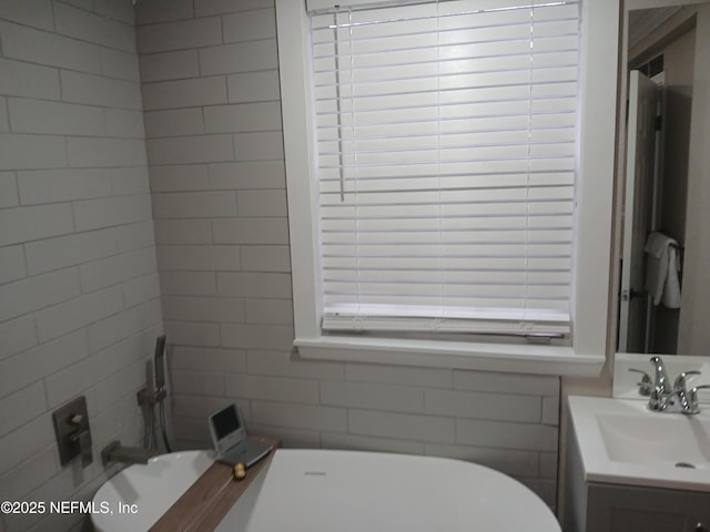 full bath with a freestanding bath and vanity