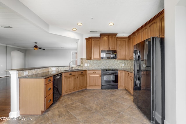 kitchen featuring sink, kitchen peninsula, stone counters, decorative backsplash, and black appliances