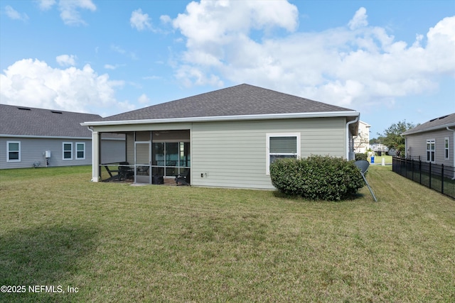 back of property with a lawn and a sunroom