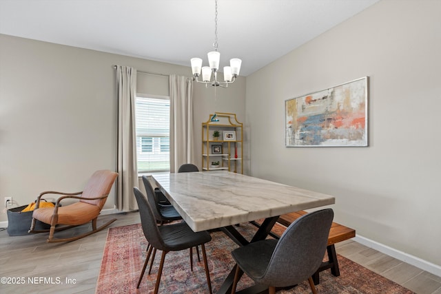 dining space with an inviting chandelier and light wood-type flooring