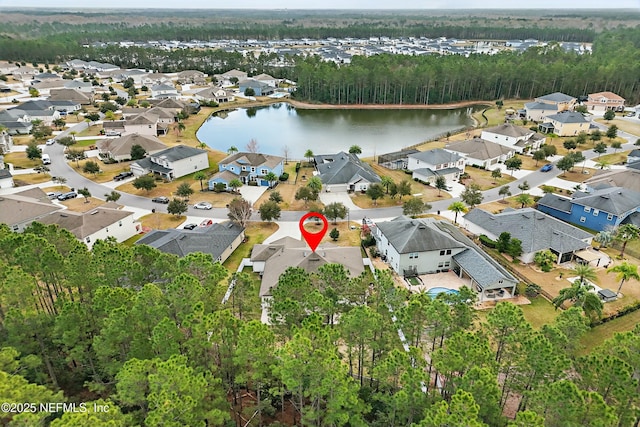 drone / aerial view with a residential view and a water view