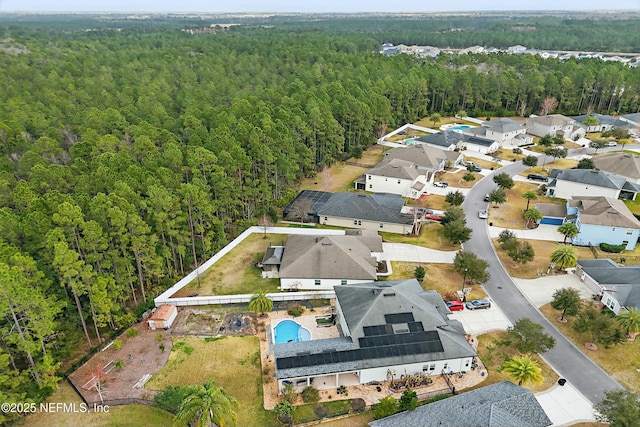 birds eye view of property featuring a residential view and a forest view