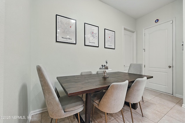 dining room featuring light tile patterned floors and baseboards