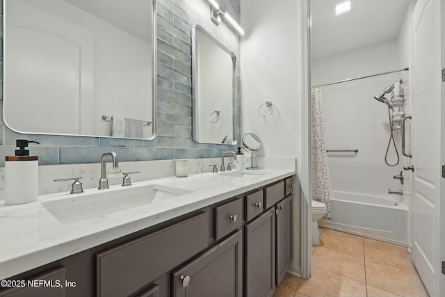 bathroom with tile patterned flooring, toilet, backsplash, and a sink