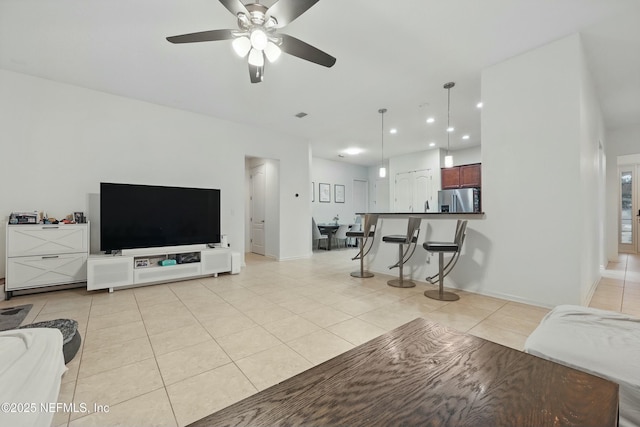 living area with recessed lighting, baseboards, light tile patterned flooring, and a ceiling fan