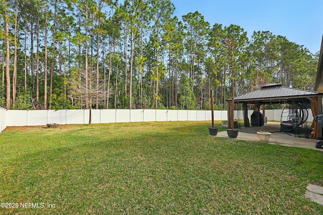 view of yard featuring a gazebo, a patio area, and a fenced backyard