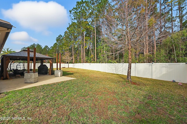 view of yard featuring a gazebo, a fenced backyard, and a patio area