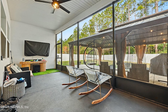 sunroom featuring a ceiling fan