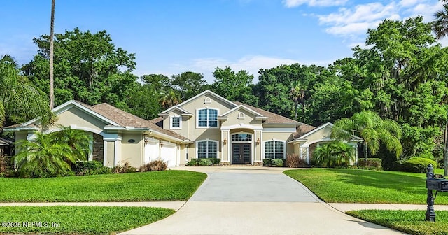 view of front of home featuring a garage and a front yard