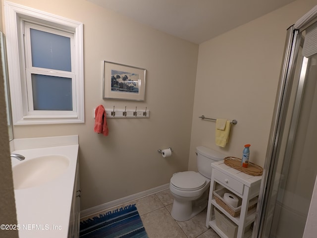 bathroom featuring vanity, tile patterned floors, and toilet