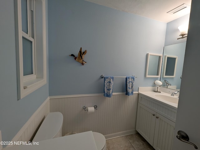 bathroom featuring tile patterned flooring, vanity, and toilet