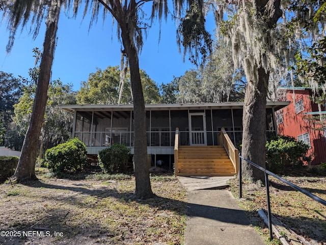 view of front of home featuring a sunroom