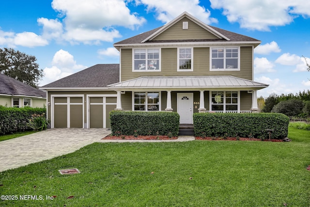 view of front facade featuring a porch, a front lawn, decorative driveway, and an attached garage