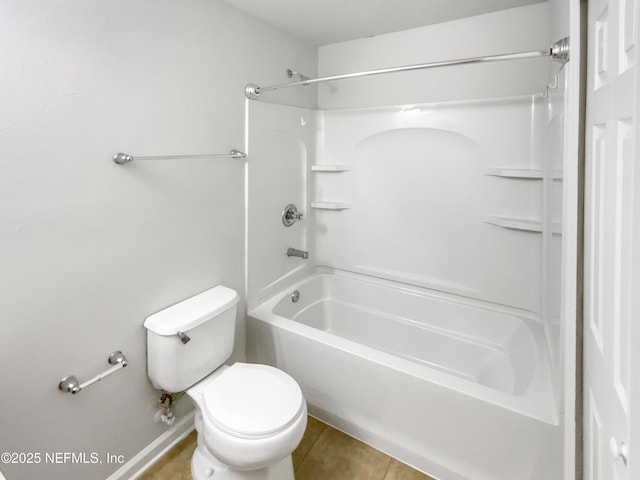 bathroom with toilet, tub / shower combination, and tile patterned flooring