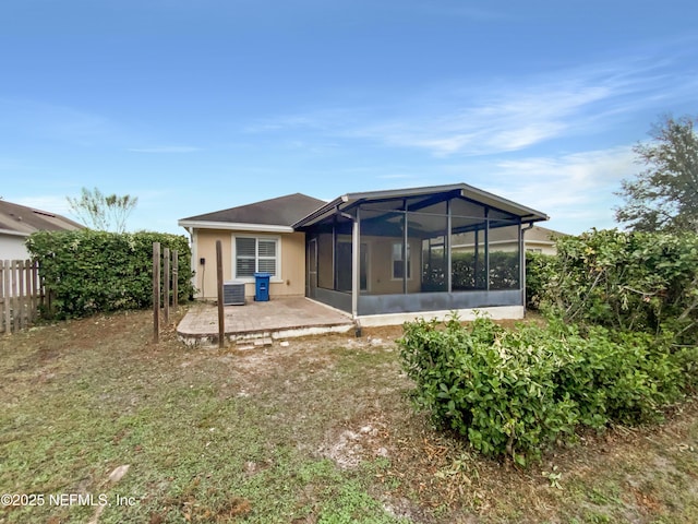 rear view of property with central AC, a sunroom, and a patio