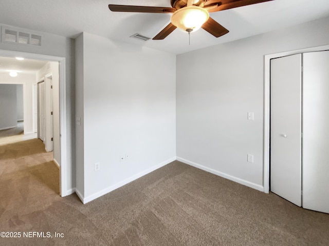 unfurnished bedroom featuring ceiling fan, light colored carpet, and a closet