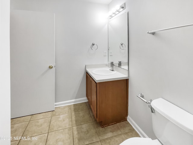 bathroom featuring vanity, tile patterned floors, and toilet