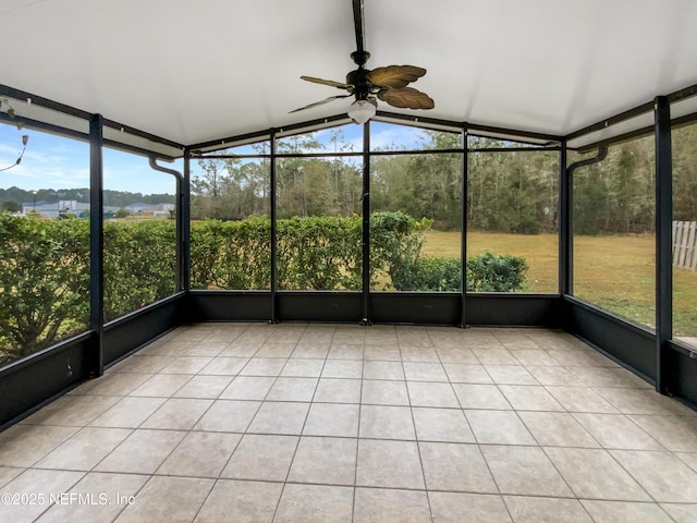 unfurnished sunroom featuring lofted ceiling, a wealth of natural light, and ceiling fan