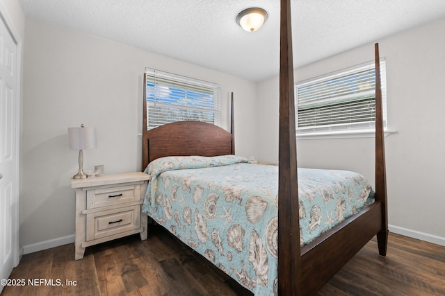 bedroom featuring dark wood-type flooring and a textured ceiling