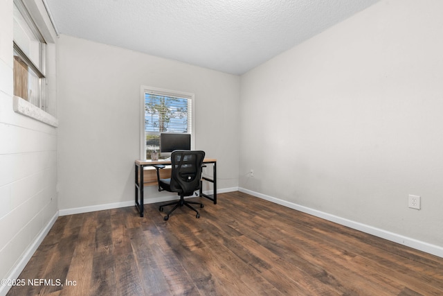 office space featuring dark wood-type flooring and a textured ceiling