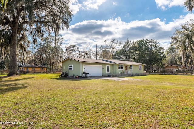 back of house with a garage and a lawn