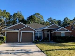 view of front of property with a garage and a front yard