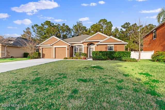 ranch-style house with a garage and a front lawn