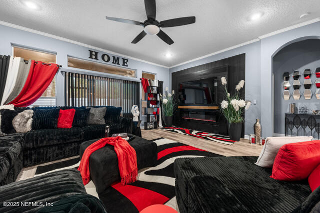 living room featuring ornamental molding, hardwood / wood-style floors, and ceiling fan