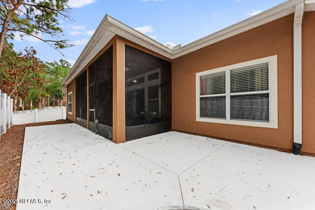 rear view of house with a sunroom and a patio area