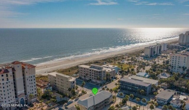 birds eye view of property with a water view and a view of the beach